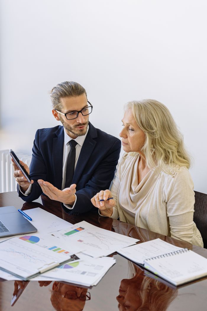 Crafting Captivating Headlines: Your awesome post title goes here Professional business discussion between a consultant and client in an office setting.